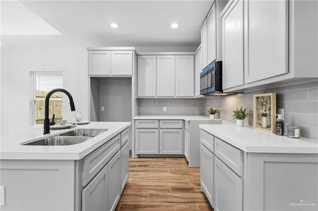 a kitchen with stainless steel appliances granite countertop a sink and cabinets