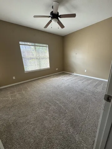 a bathroom with a granite countertop sink a toilet a mirror and bathtub