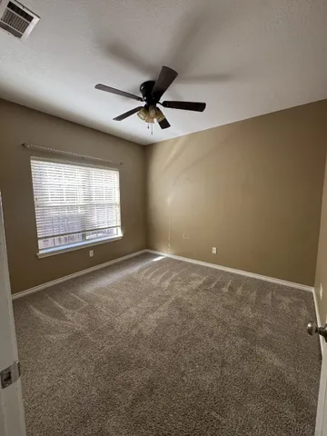 a spacious bathroom with a granite countertop sink and a mirror