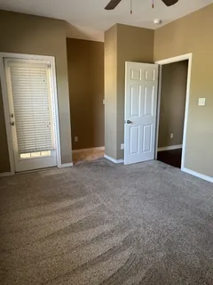 a bathroom with a granite countertop toilet a mirror and a sink