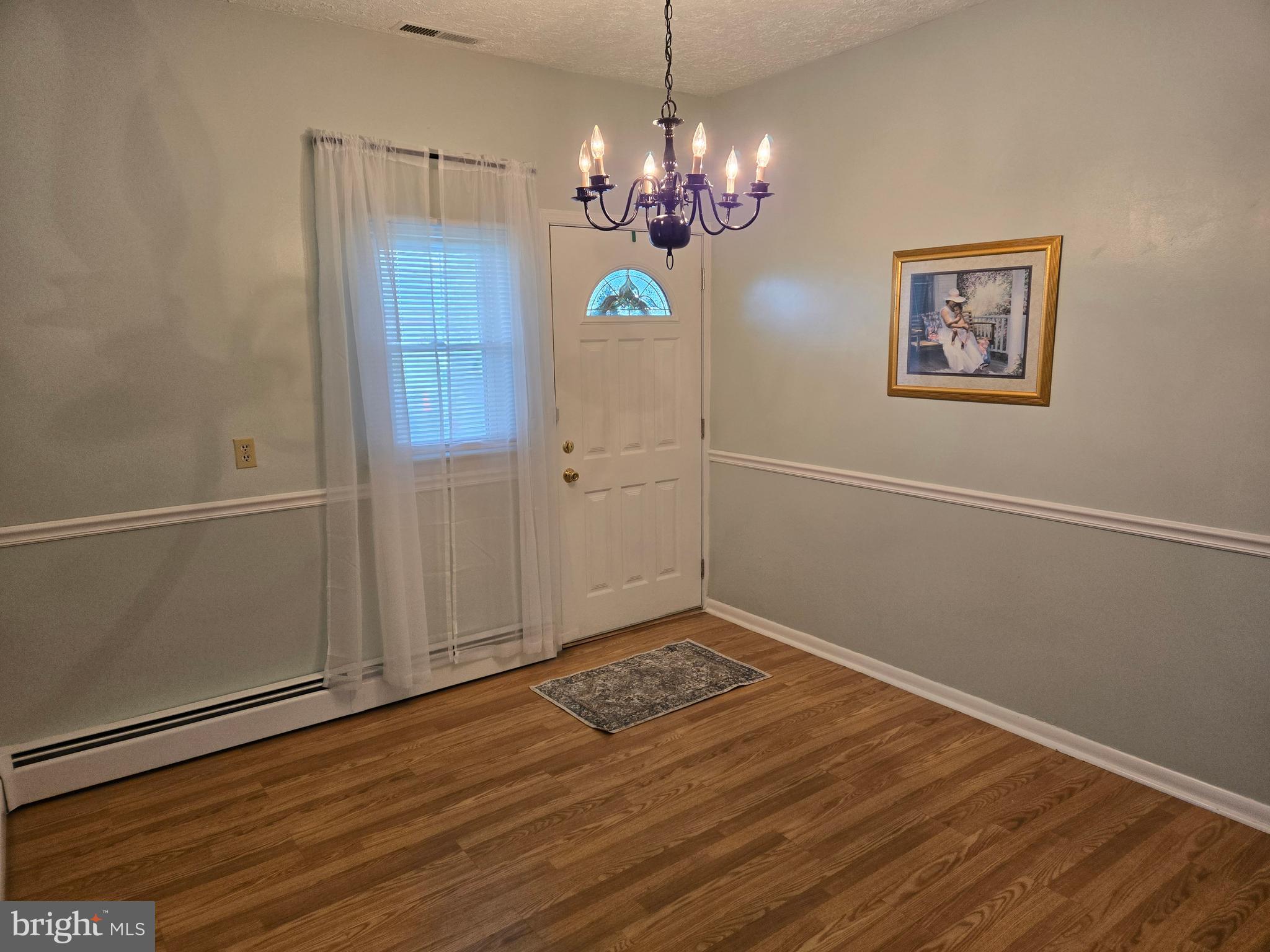 2414 Willoughby Beach Road Edgewood, MD 21040 - Photo 19 of 35 a view of a hallway with a chandelier wooden floor and chandelier