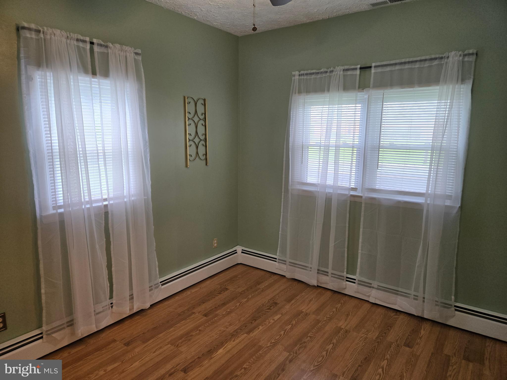 2414 Willoughby Beach Road Edgewood, MD 21040 - Photo 22 of 35 an empty room with wooden floor and windows