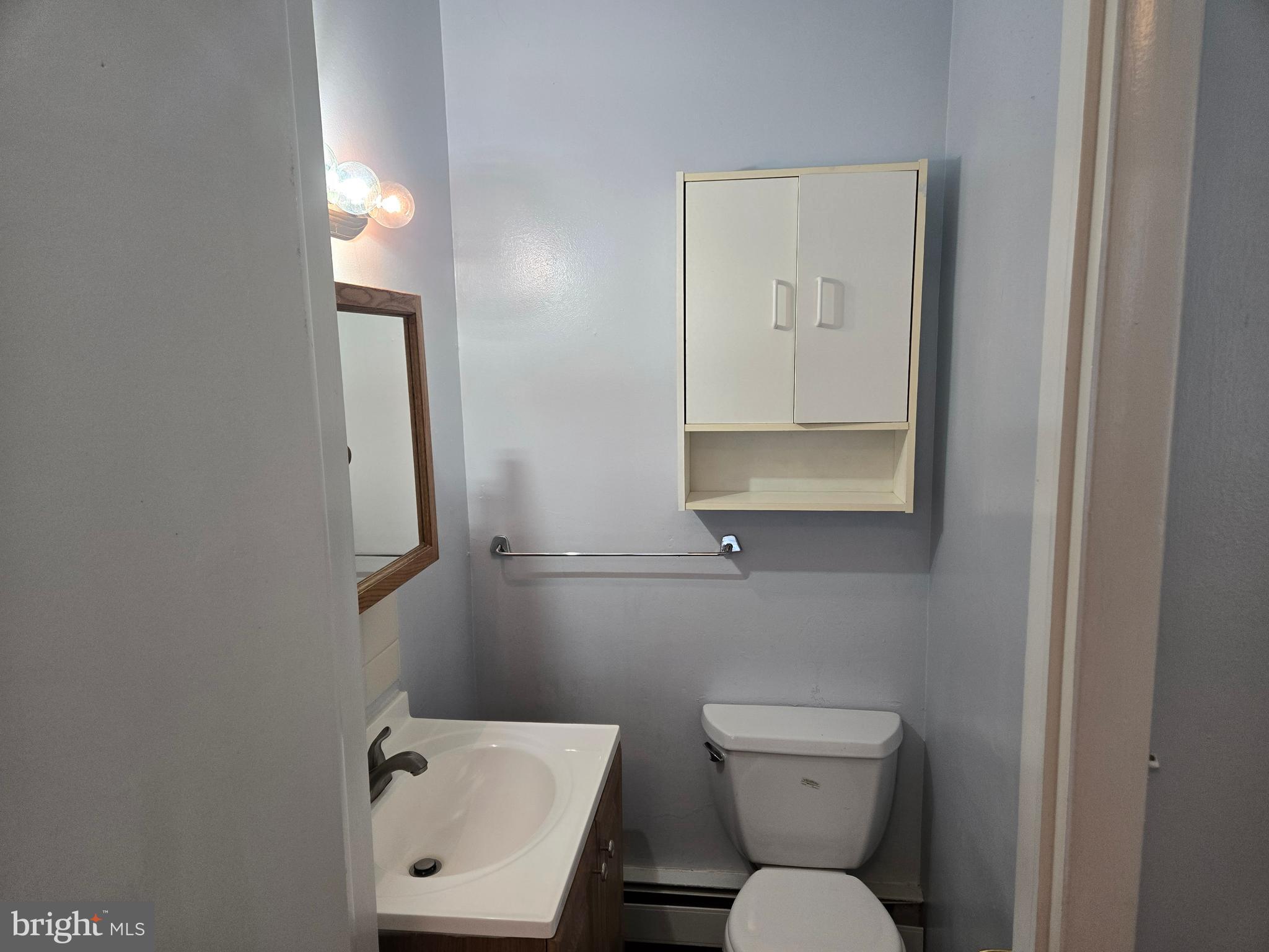 2414 Willoughby Beach Road Edgewood, MD 21040 - Photo 29 of 35 a bathroom with a toilet a sink and mirror