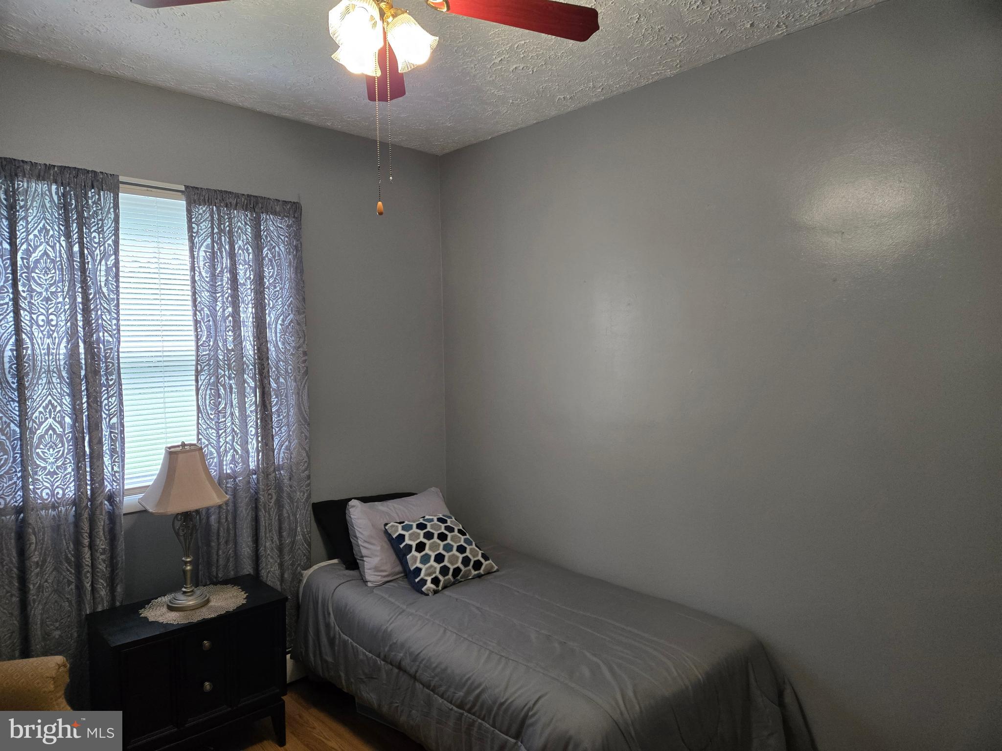 2414 Willoughby Beach Road Edgewood, MD 21040 - Photo 31 of 35 a bedroom with a bed and a chandelier