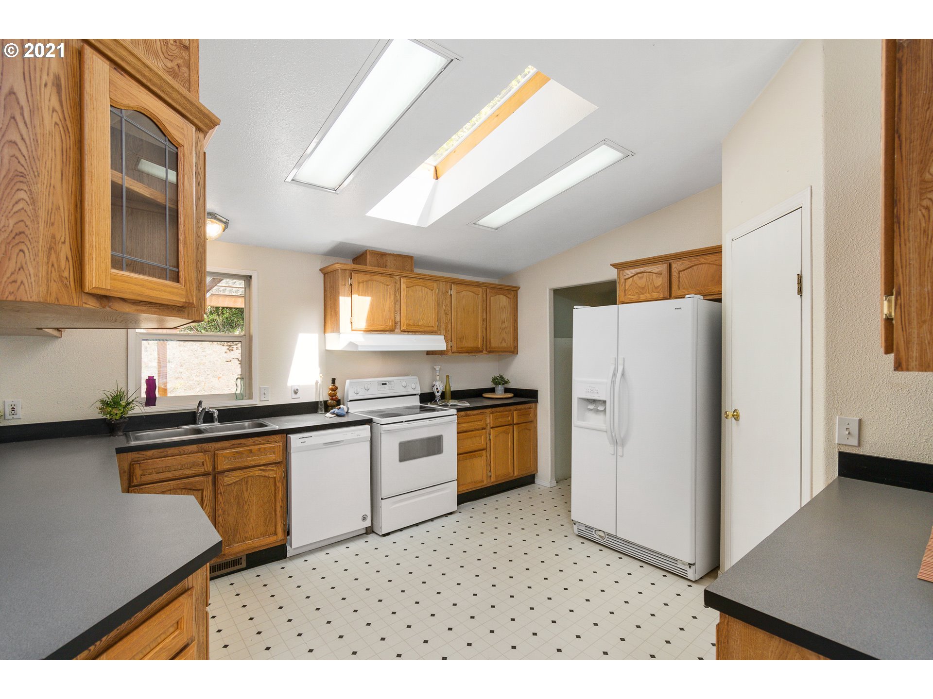 75367 Fern Hill Road Rainier, OR 97048 - Photo 8 of 27 a kitchen with stainless steel appliances granite countertop a refrigerator a sink dishwasher a stove with wooden floor