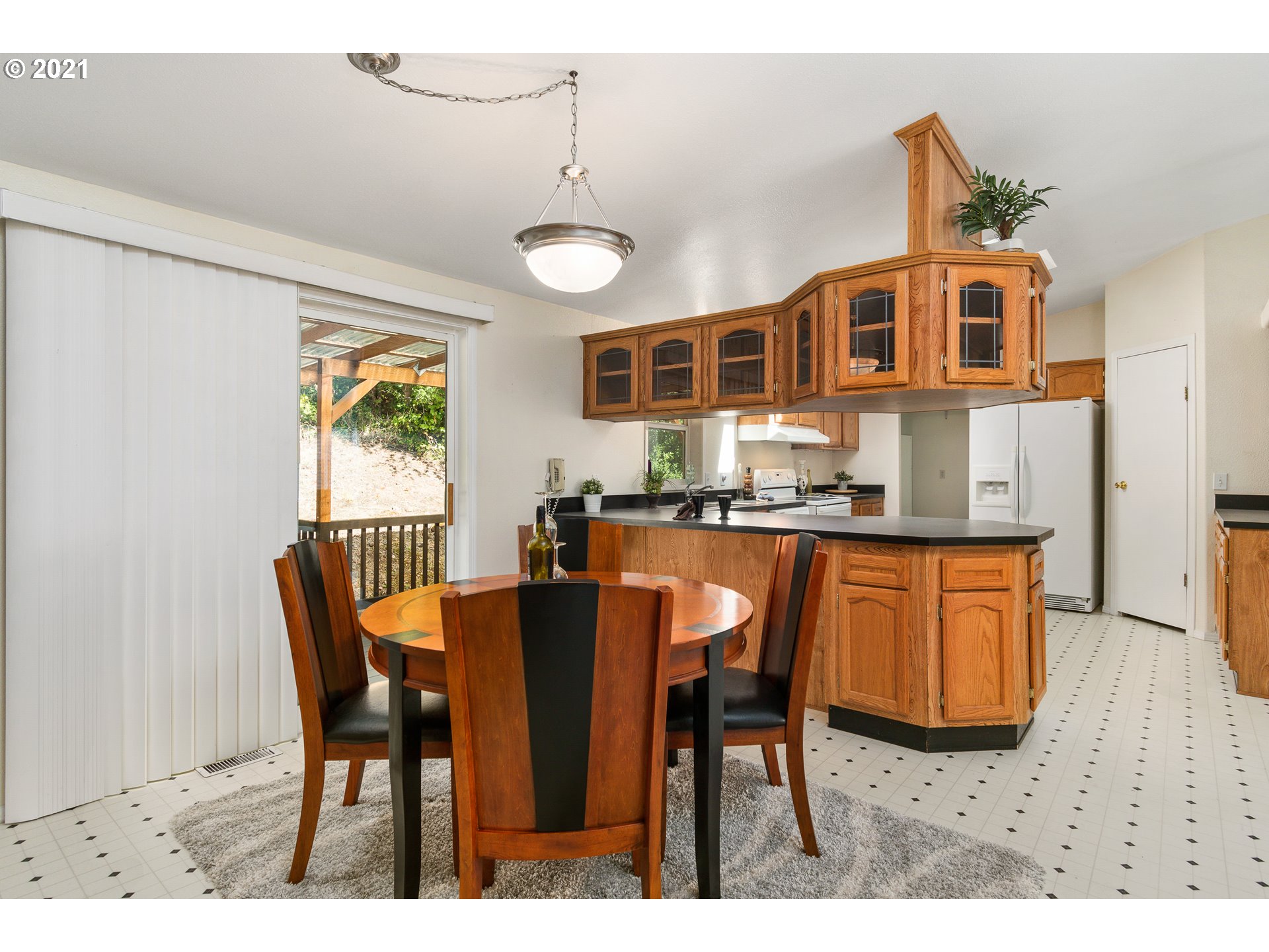75367 Fern Hill Road Rainier, OR 97048 - Photo 9 of 27 a dining room with stainless steel appliances granite countertop a dining table chairs and a refrigerator