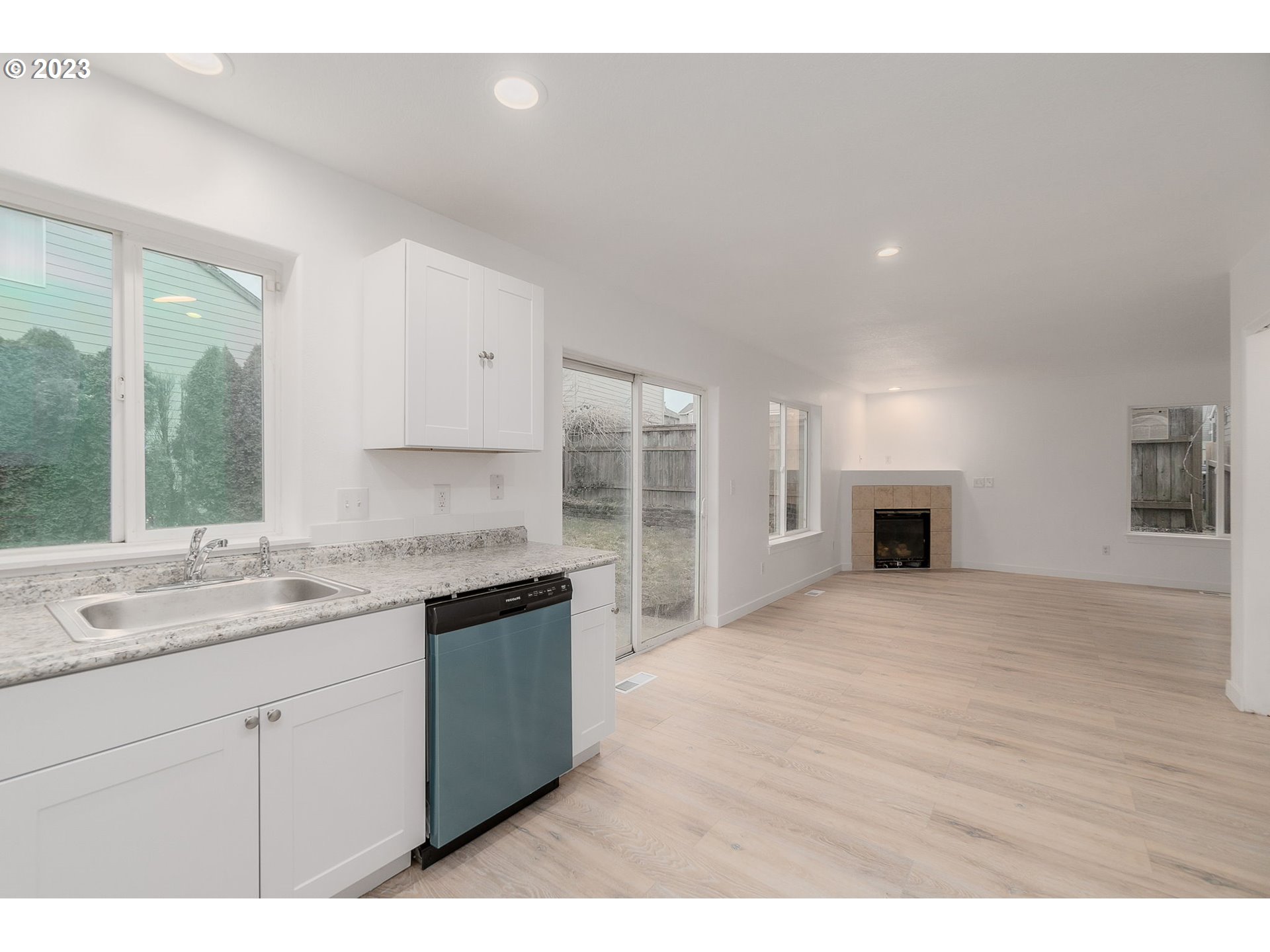 16506 Northeast 14th Avenue Ridgefield, WA 98642 - Photo 11 of 24 a kitchen with a sink cabinets and wooden floor