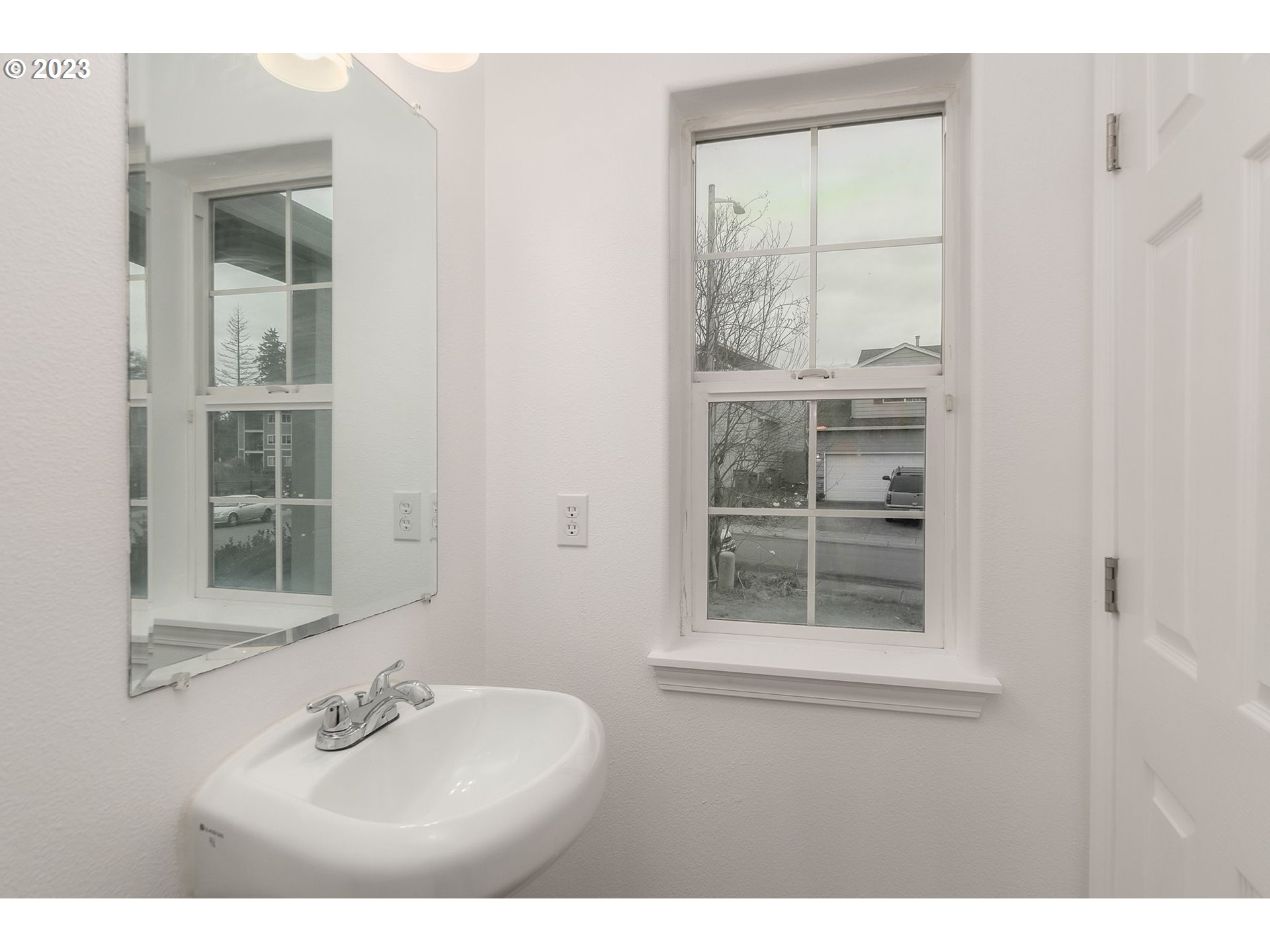 16506 Northeast 14th Avenue Ridgefield, WA 98642 - Photo 12 of 24 a bathroom with a sink window and a mirror