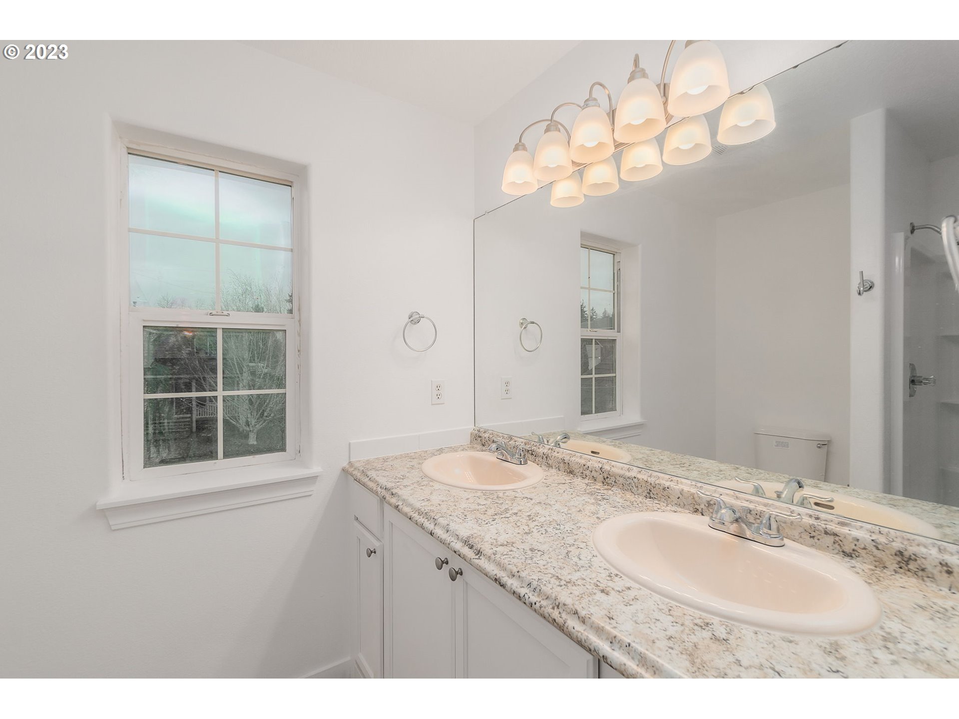 16506 Northeast 14th Avenue Ridgefield, WA 98642 - Photo 18 of 24 a bathroom with a granite countertop sink a large mirror and a window