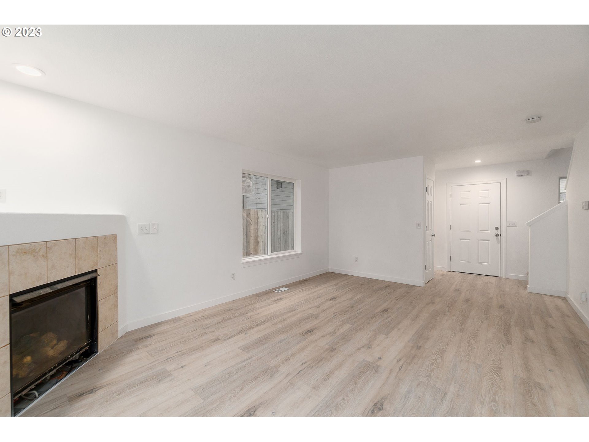 16506 Northeast 14th Avenue Ridgefield, WA 98642 - Photo 4 of 24 a view of an empty room with a fireplace and a window