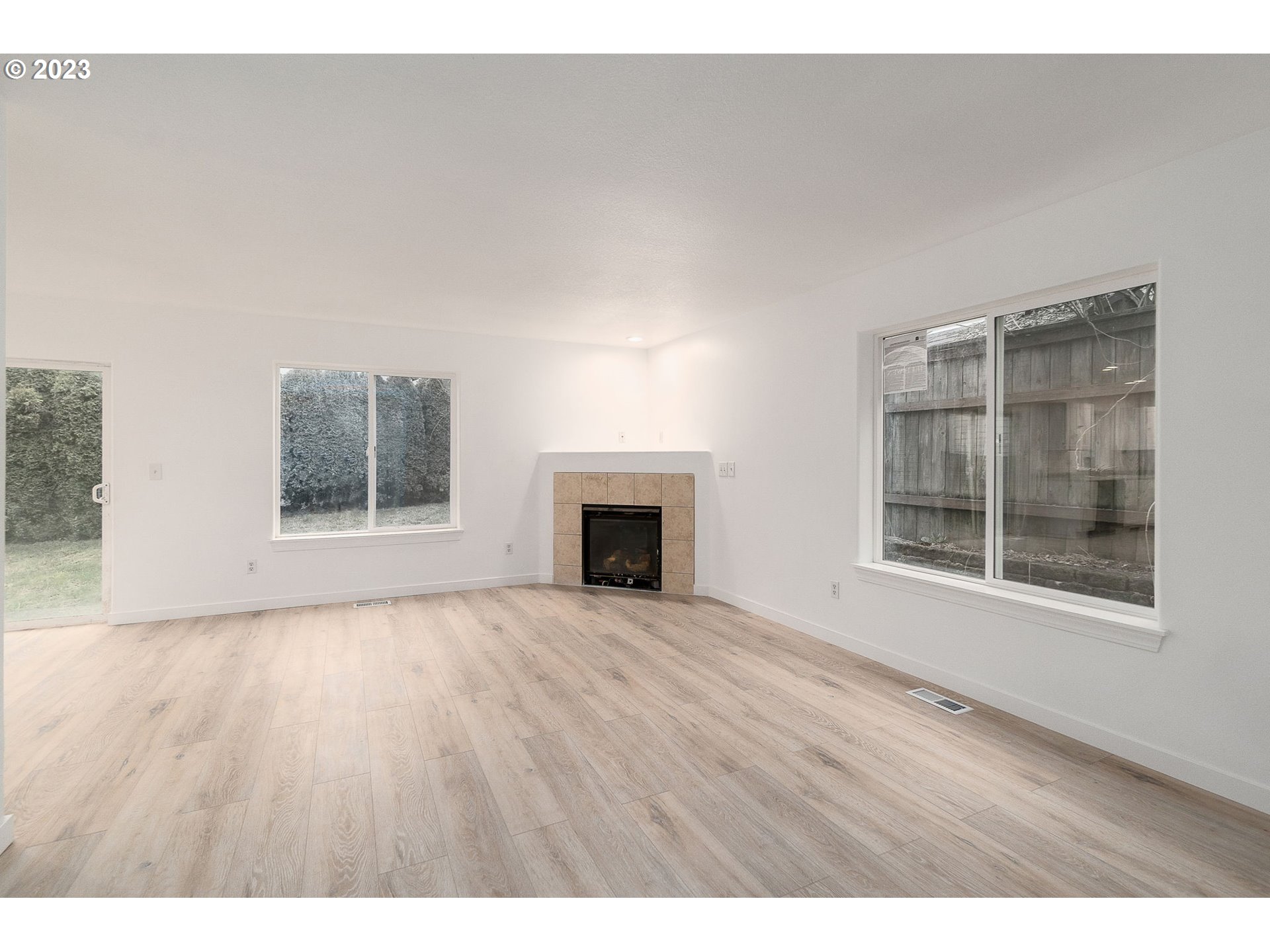 16506 Northeast 14th Avenue Ridgefield, WA 98642 - Photo 6 of 24 a view of an empty room with a window and wooden floor