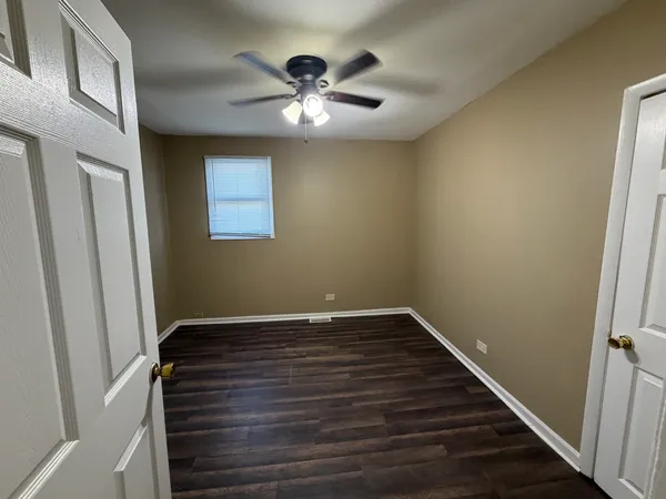 a view of room with window and ceiling fan