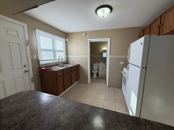 a kitchen with stainless steel appliances a refrigerator and a stove
