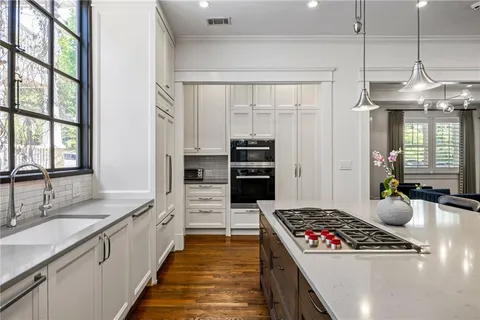 a kitchen with stainless steel appliances kitchen island a stove and a sink