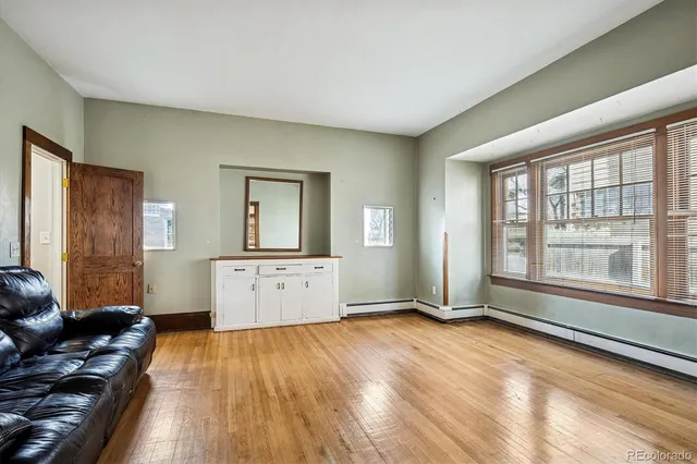 a living room with furniture and large window
