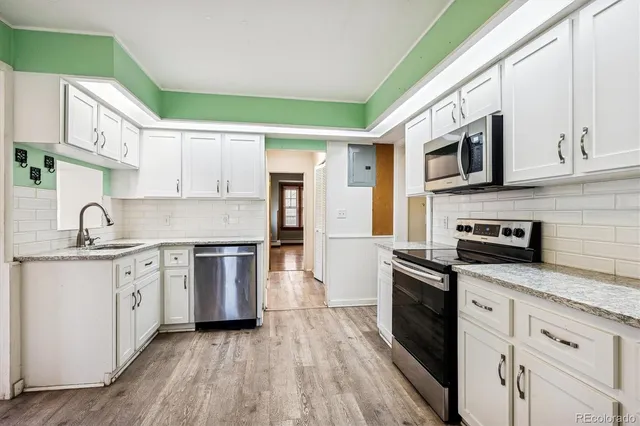 a kitchen with stainless steel appliances granite countertop a sink and stove top oven