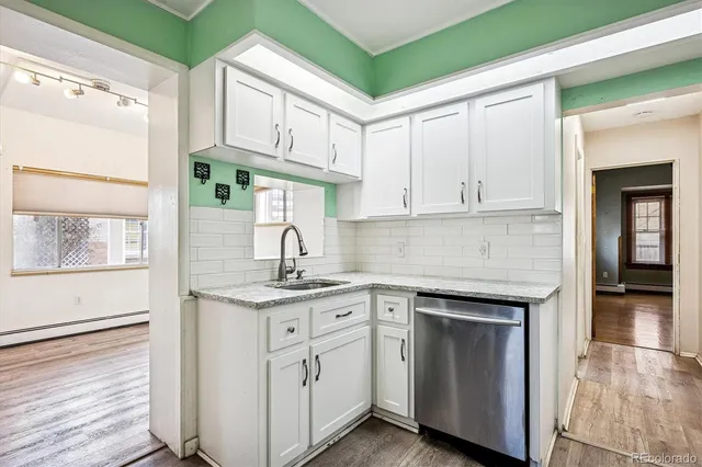 a kitchen with white cabinets and a sink