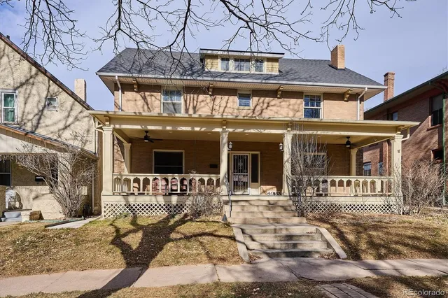 a view of a building with a bench in patio