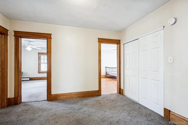 an empty room with windows and closet