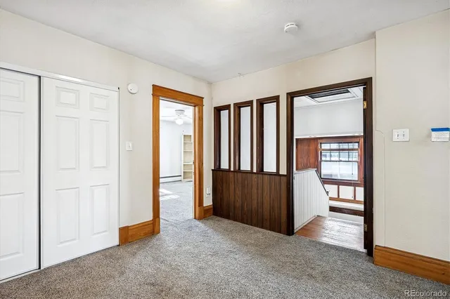 a view of a room with wooden floor and furniture