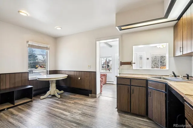 a kitchen with sink cabinets and wooden floor