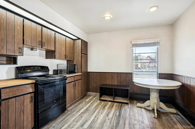 a kitchen with kitchen island granite countertop wooden cabinets and a sink