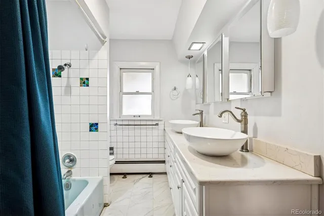 a view of an empty room with window wooden floor and a ceiling fan
