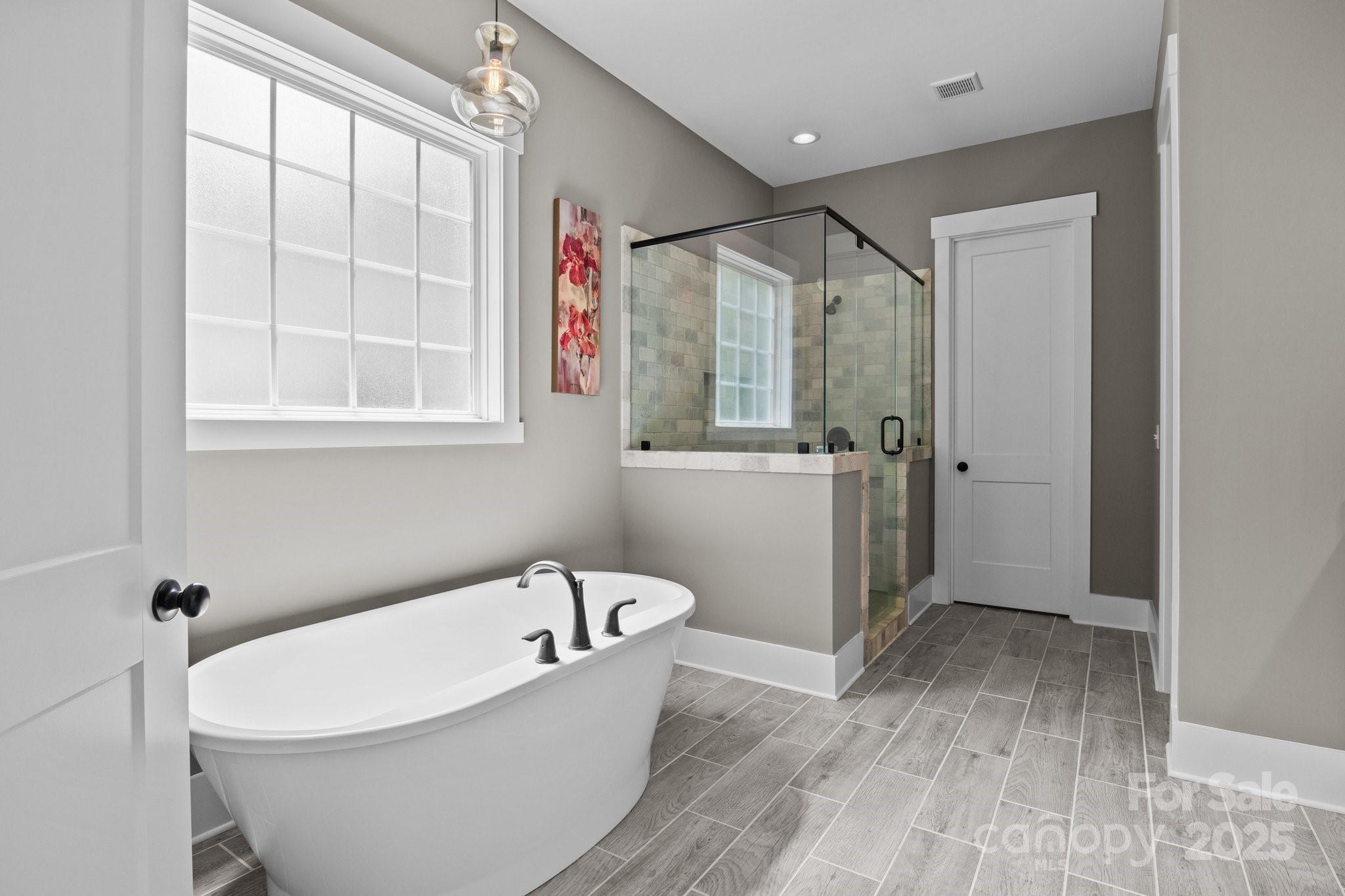 6743 Fox Ridge Circle Davidson, NC 28036 - Photo 26 of 48 a bath room with a bathtub and a shower