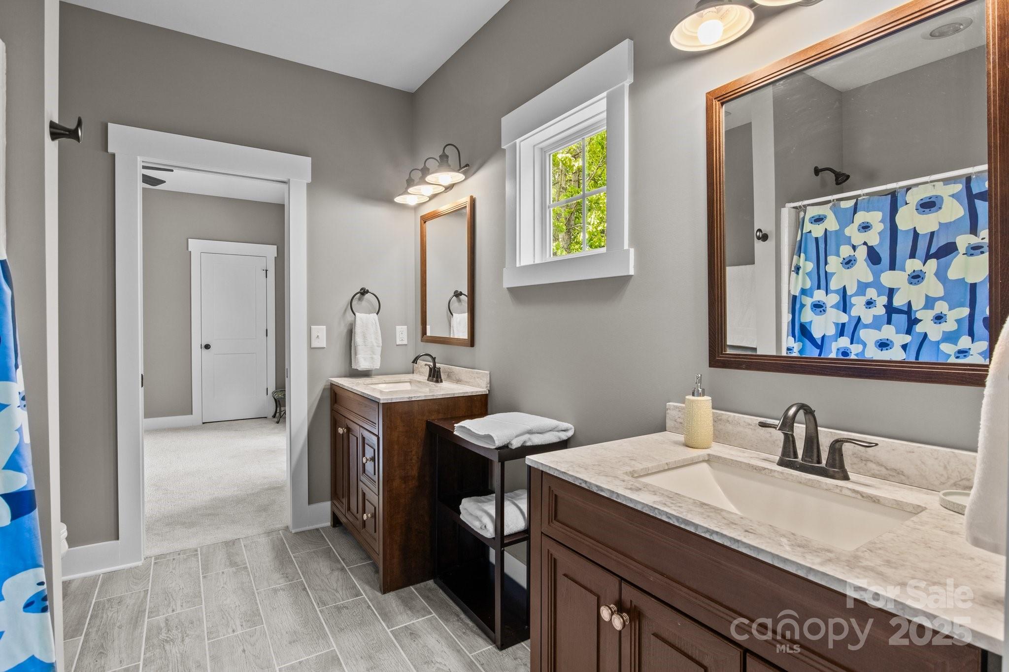 6743 Fox Ridge Circle Davidson, NC 28036 - Photo 29 of 48 a en suite bathroom with a granite countertop sink a mirror and a bathtub
