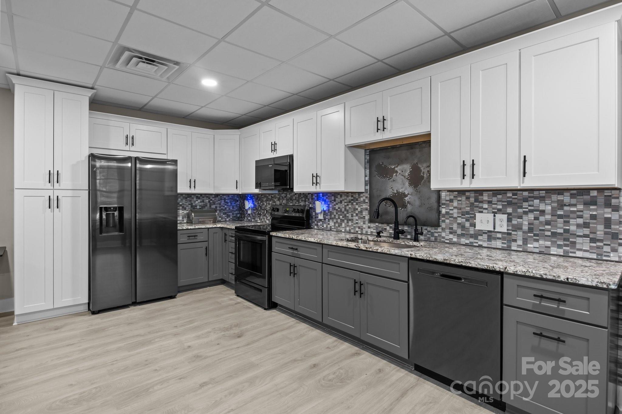 6743 Fox Ridge Circle Davidson, NC 28036 - Photo 36 of 48 a kitchen with stainless steel appliances granite countertop a refrigerator a sink dishwasher a stove and white cabinets