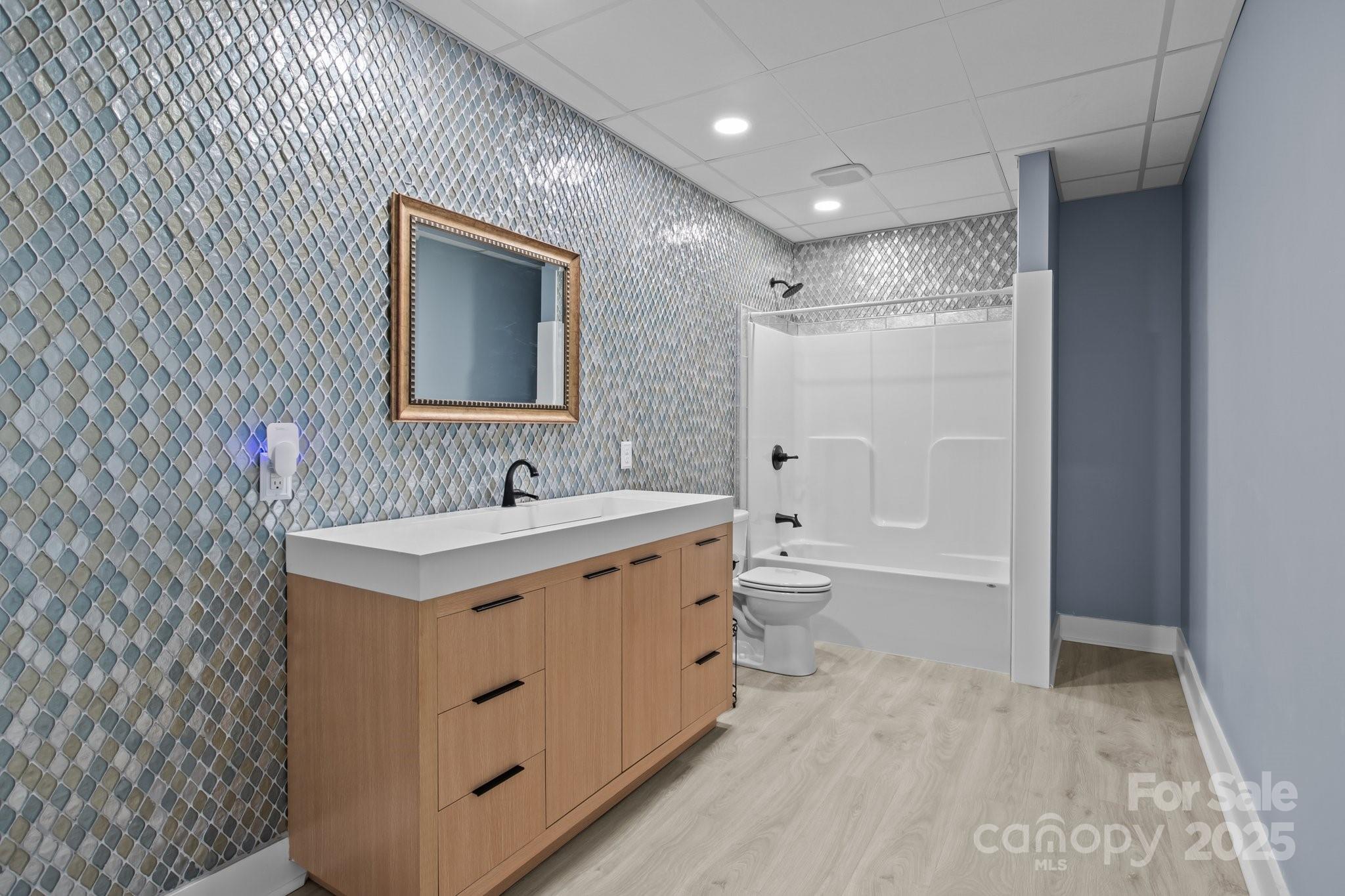 6743 Fox Ridge Circle Davidson, NC 28036 - Photo 39 of 48 a bathroom with a granite countertop sink mirror bathtub and toilet