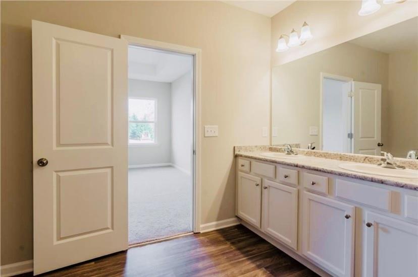 66 Wisteria Way Winder, GA 30680 - Photo 13 of 34 a bathroom with a double vanity sink and mirror