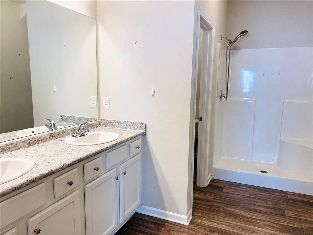 66 Wisteria Way Winder, GA 30680 - Photo 14 of 34 a bathroom with a granite countertop sink and a mirror