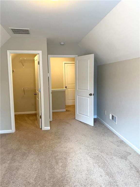 66 Wisteria Way Winder, GA 30680 - Photo 22 of 34 an empty room with closet and mirror