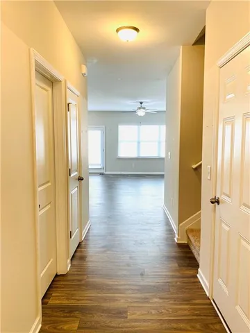 a view of a hallway with wooden floor