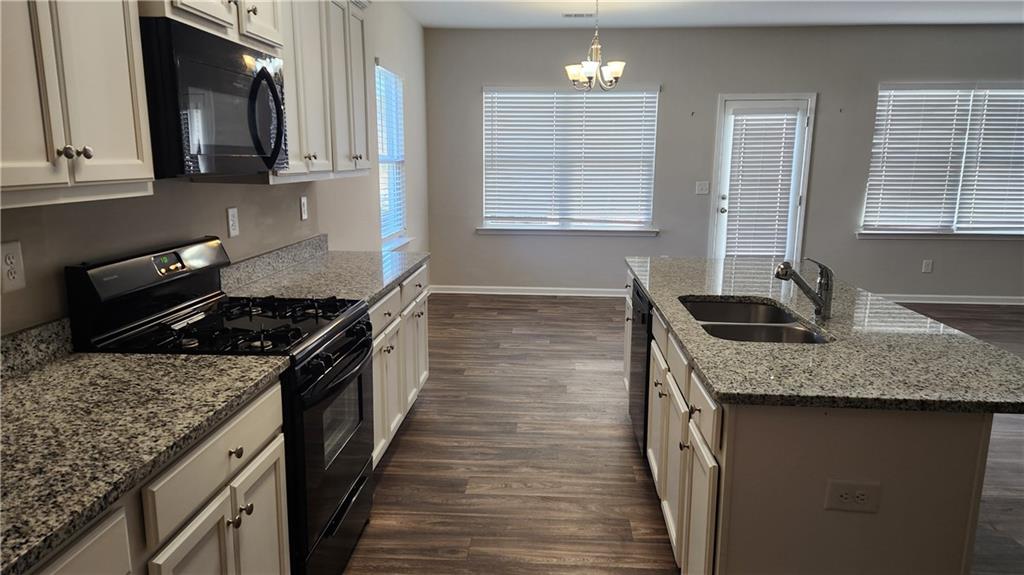 66 Wisteria Way Winder, GA 30680 - Photo 9 of 34 a kitchen with stainless steel appliances granite countertop a sink stove and cabinets