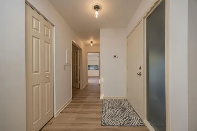a kitchen with stainless steel appliances granite countertop a kitchen island hardwood floor and a sink