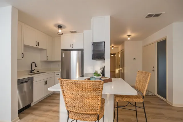 a view of a kitchen with a stove and a refrigerator