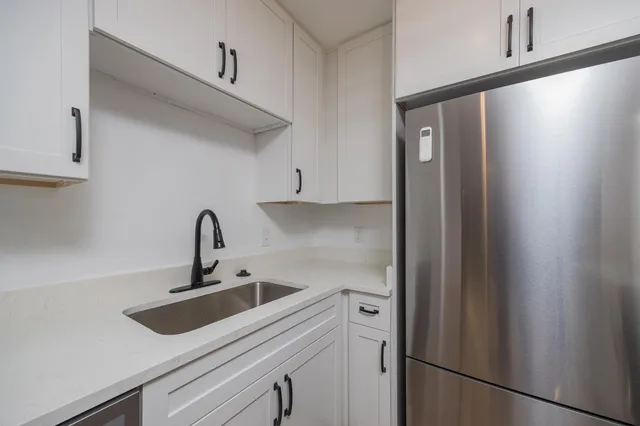 a kitchen with stainless steel appliances a refrigerator stove and microwave