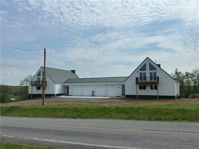 a house that has a tree in front of it