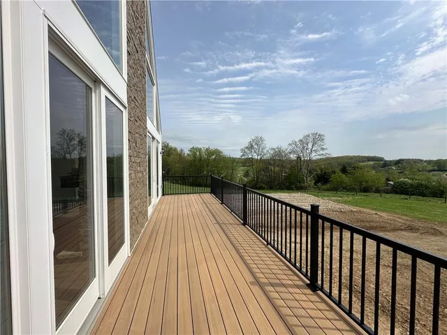 a view of balcony with wooden floor and fence