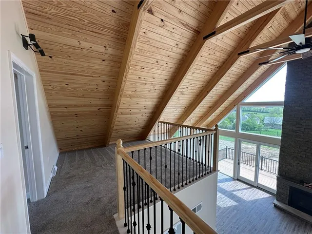 a view of staircase with railing and white walls