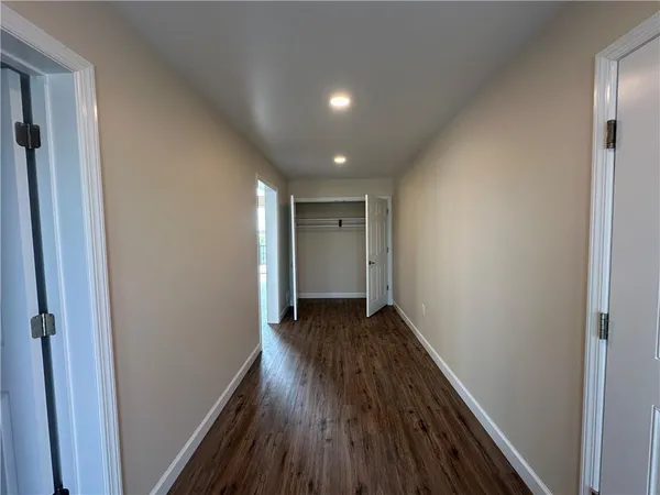a view of hallway with wooden floor