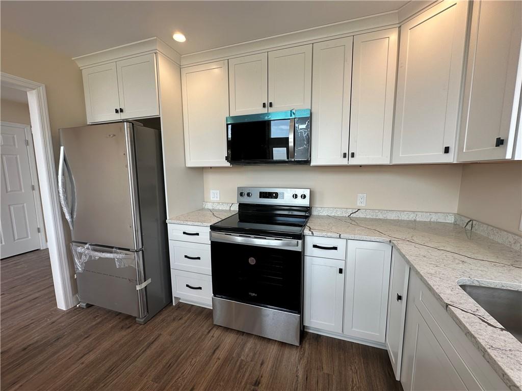 1121 Three Degree Road Butler, PA 16002 - Photo 8 of 28 a kitchen with stainless steel appliances white cabinets and wooden floors