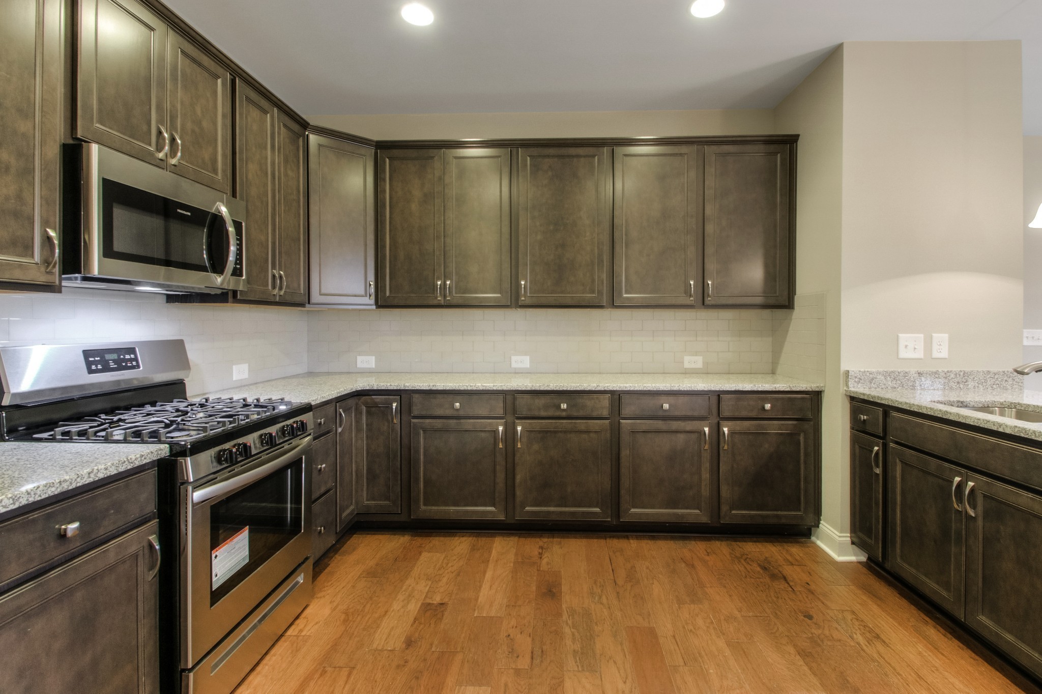 334 Buckner Cir Mount Mount Juliet, TN 37122 - Photo 13 of 40 a kitchen with stainless steel appliances granite countertop a stove a sink and a microwave