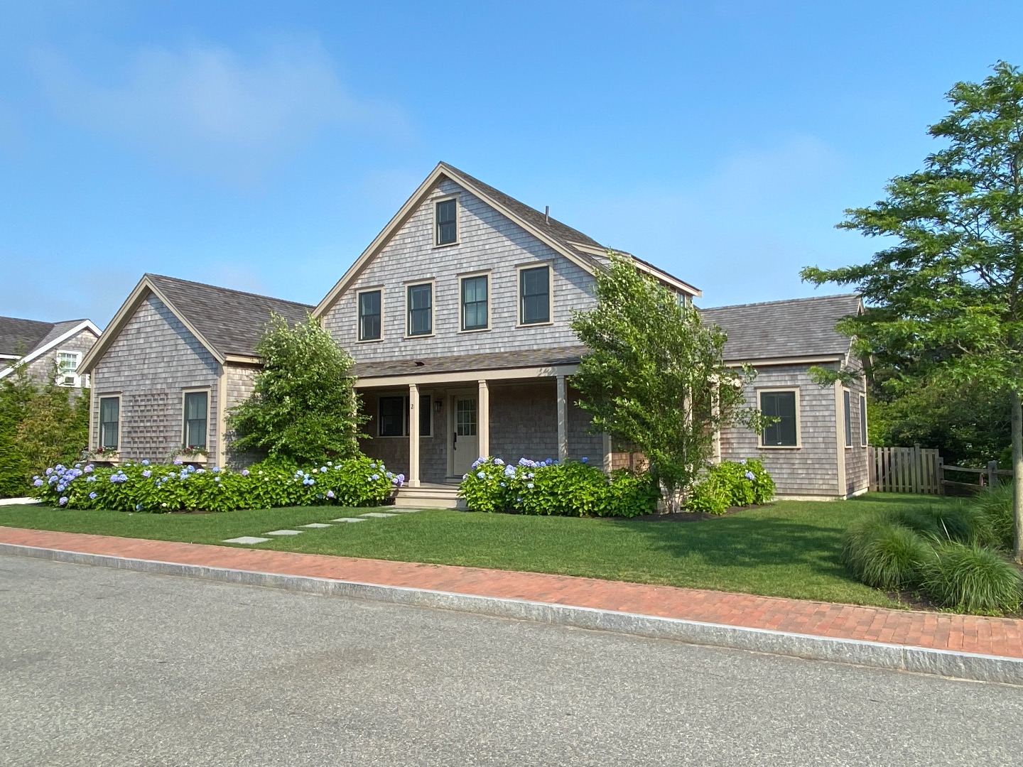 2 Wood Lily Road Nantucket, MA 02554 - Photo 2 of 38 a front view of a house with a garden