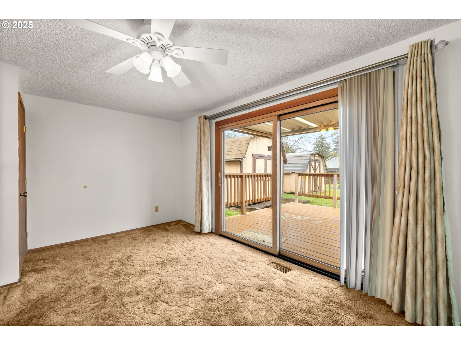 615 Cedar Street Fairview, OR 97024 - Photo 11 of 33 an empty room with chandelier fan and windows