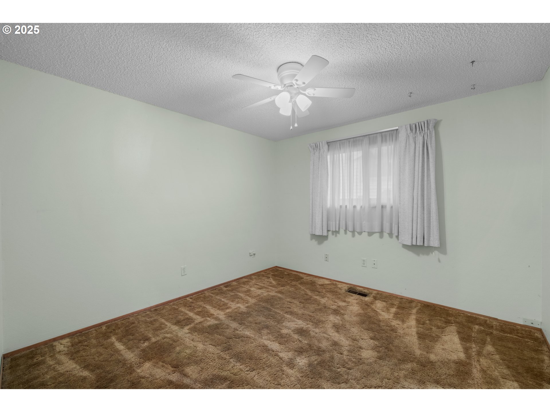 615 Cedar Street Fairview, OR 97024 - Photo 16 of 33 a view of an empty room with chandelier fan and windows