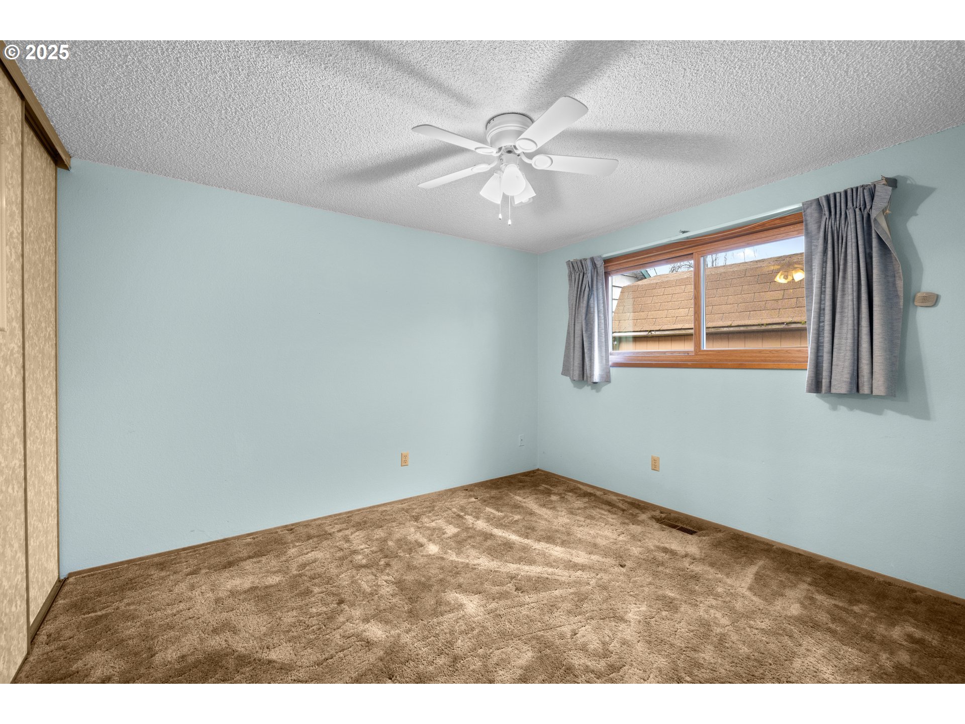 615 Cedar Street Fairview, OR 97024 - Photo 18 of 33 a view of an empty room with window and chandelier fan