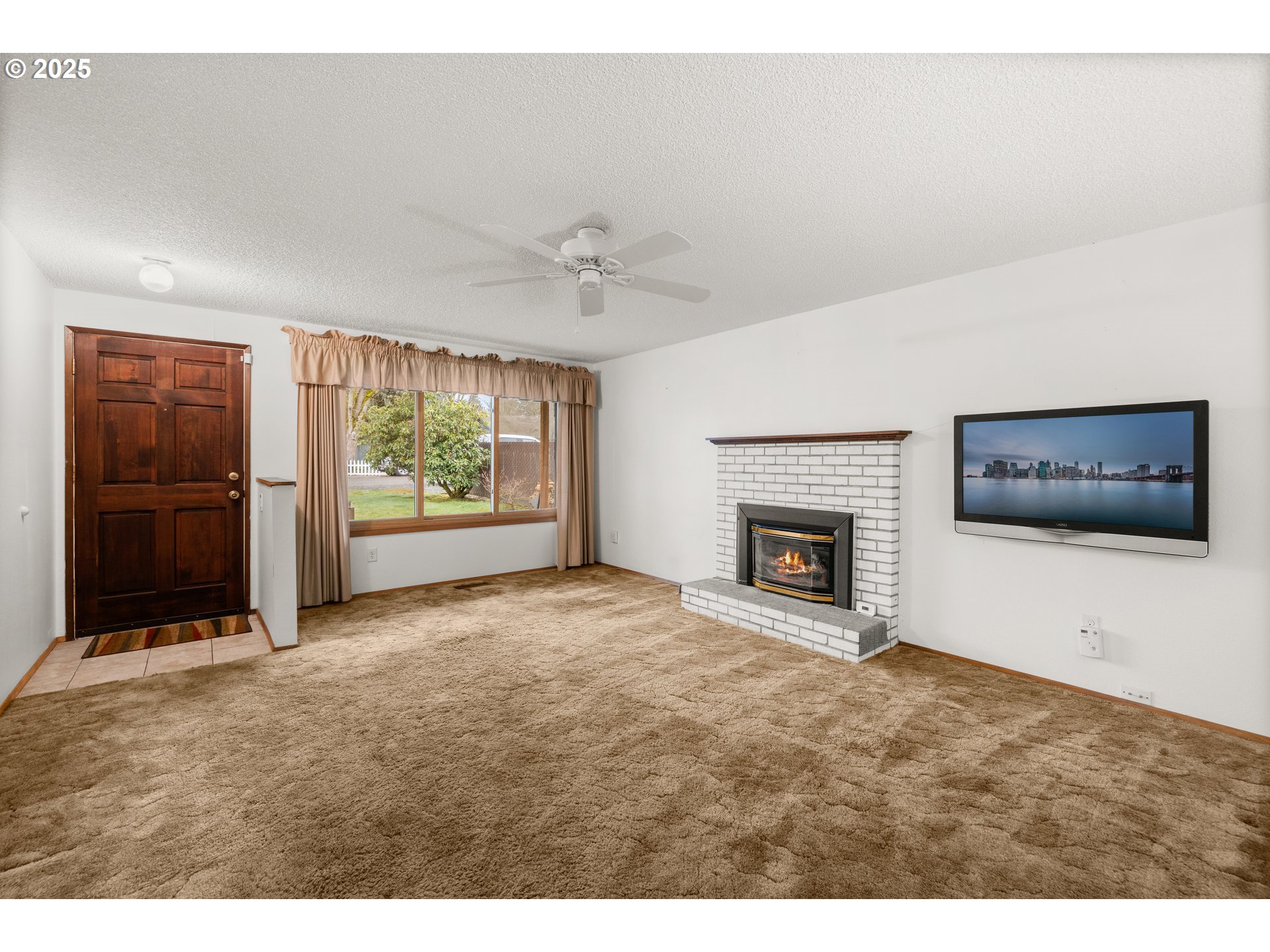 615 Cedar Street Fairview, OR 97024 - Photo 3 of 33 a view of an empty room with a fireplace and window